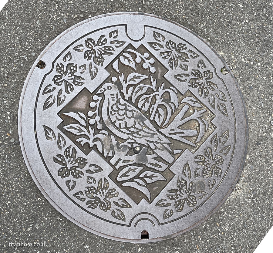 Ikeda (Osaka) - a lid with the flower, bird and tree symbolizing the city