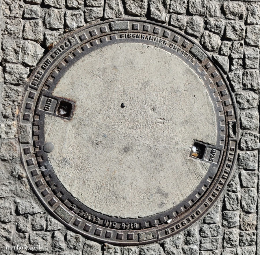 Dresden - A round concrete cover surrounded by a metal frame