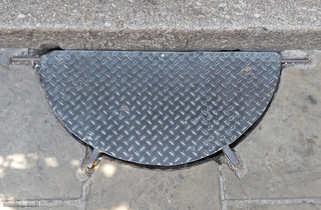 London - A sidewalk drain without a bottom section in the form of a semi-circle