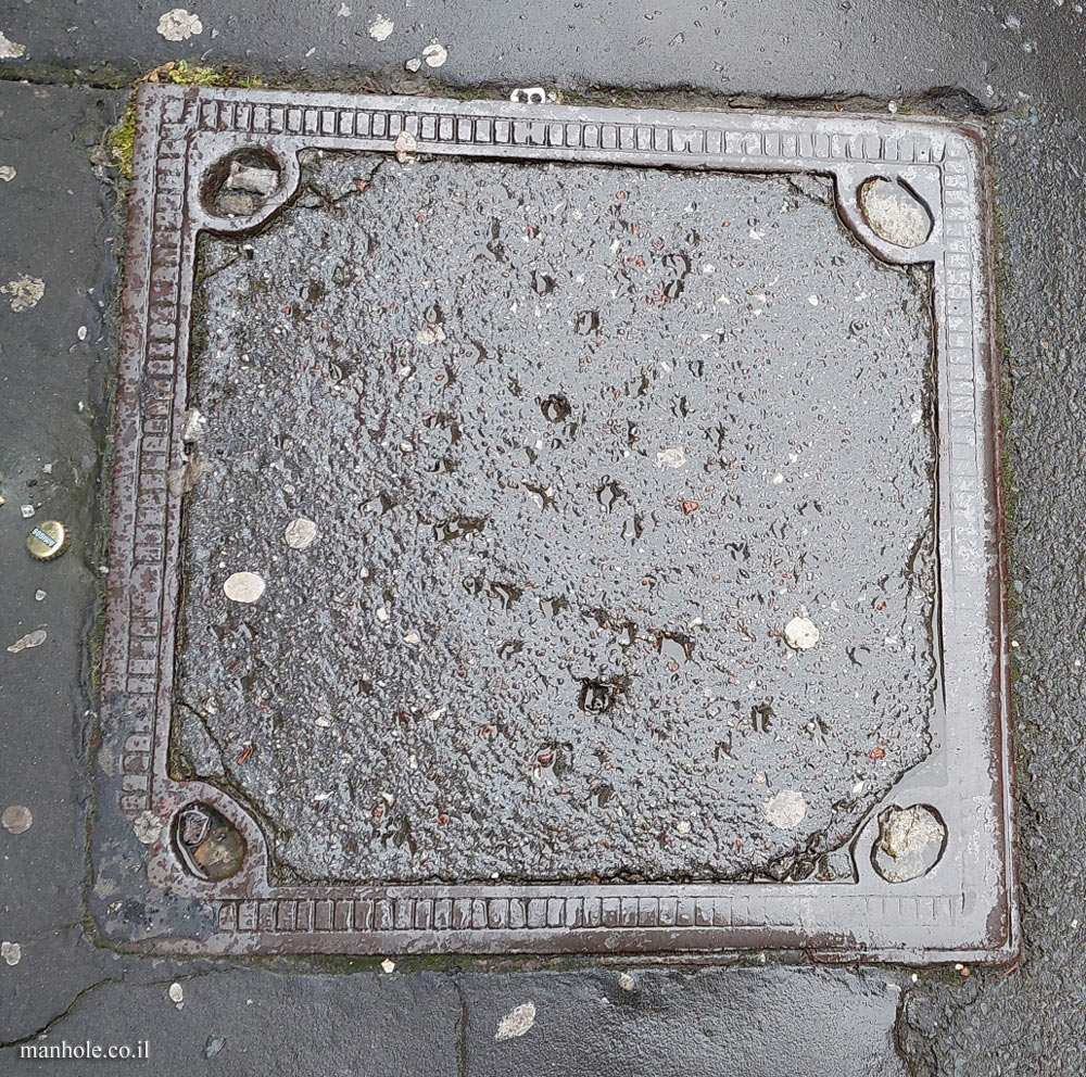 Manchester - concrete cover with a metal frame and stripes on it