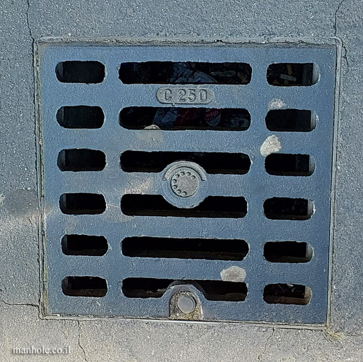 Paris - a drain cover with an icon similar to the dial of an old telephone