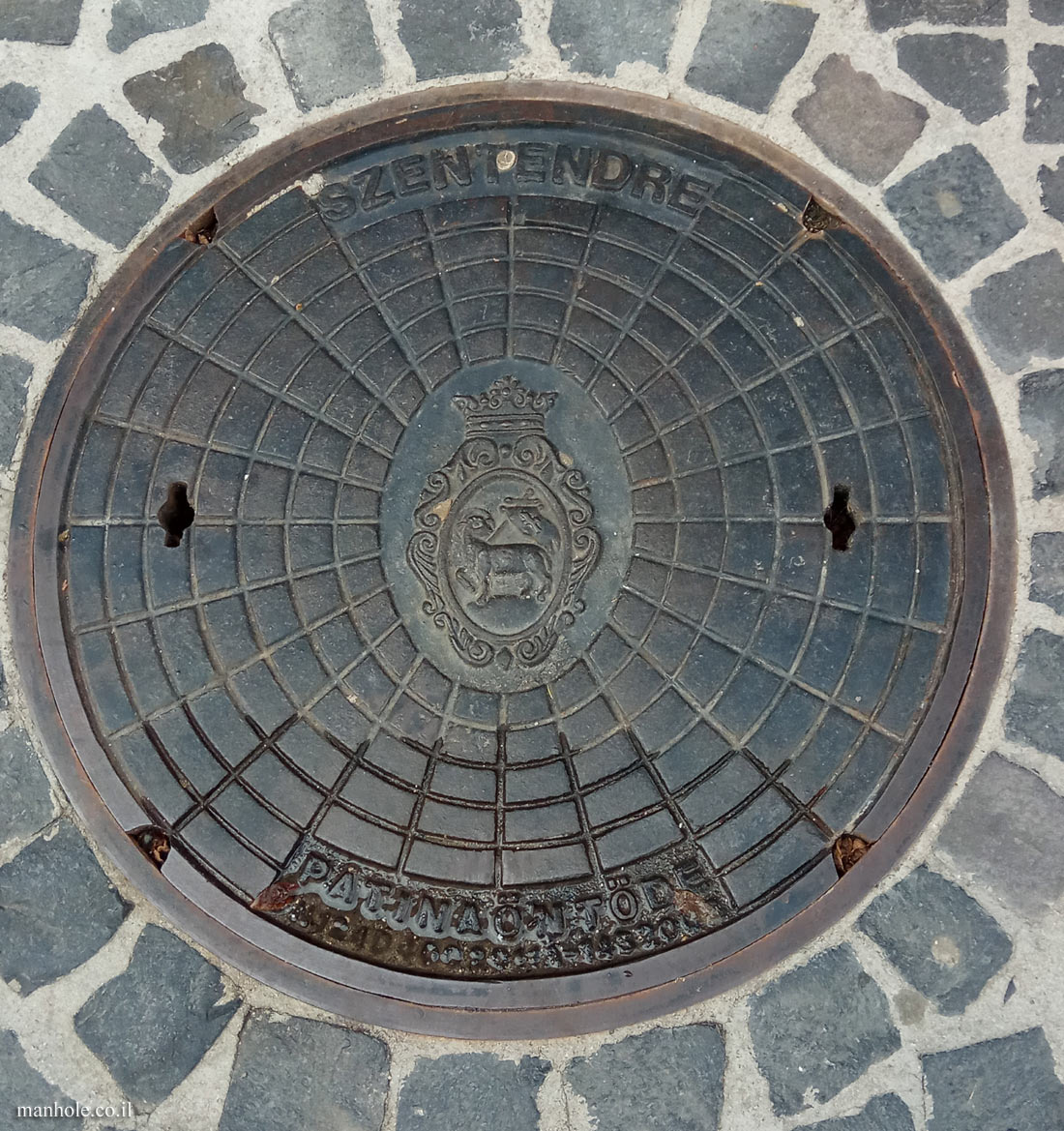 Szentendre - A lid with a network of circles and the city symbol in the center