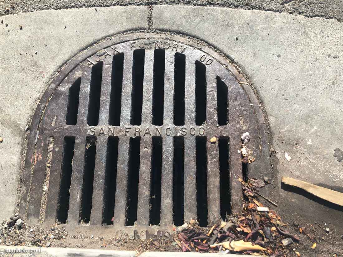 San Francisco - sidewalk drainage - half oval shaped cap