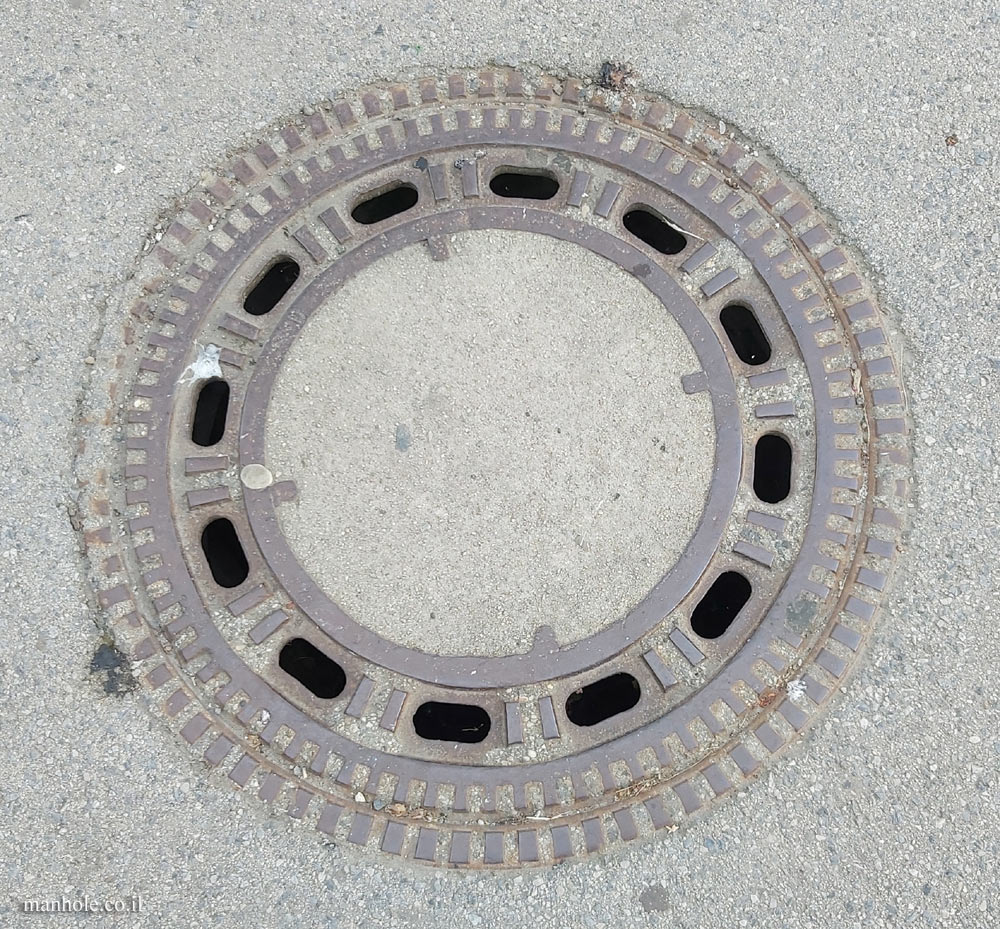 Vienna, a round concrete cover with a wide and decorated metal frame